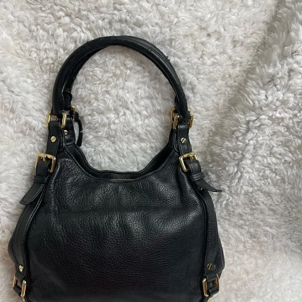 Michael Kors Black Pebble Leather Satchel with gold tone hardwares and accents.